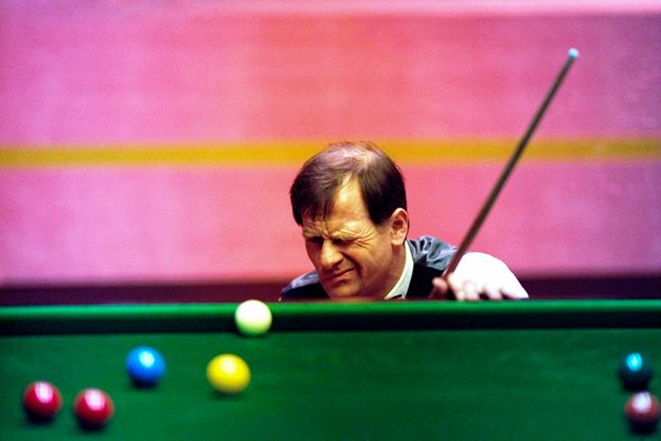 Alex Higgins of Ireland lines up a shot during the 1994 Embassy World Snooker Championships