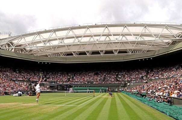 Carlos Alcaraz Spain serves v Novak Djokovic Serbia Wimbledon Final 2023