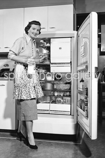 Housewife at refrigerator