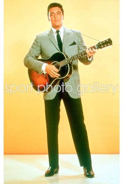Elvis Presley plays guitar in suit