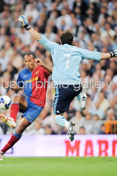 Casillas of Real Madrid blocks Thierry Henry of Barcelona 