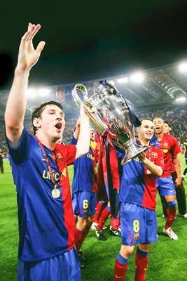 Messi and Iniesta celebrate with the trophy 