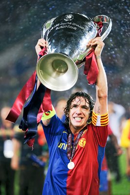 Barcelona Captain Carles Puyol lifts the trophy 