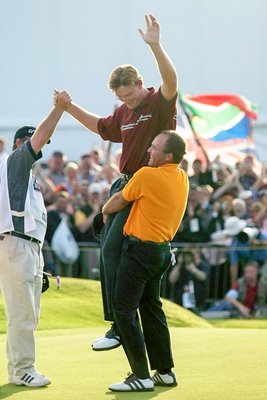 Thomas Levet  lifts champion Ernie Els