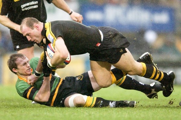 Lawrence Dallagio of Wasps is tackled by Matt Dawson of Northampton