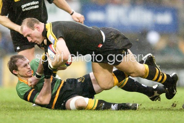 Lawrence Dallagio of Wasps is tackled by Matt Dawson of Northampton