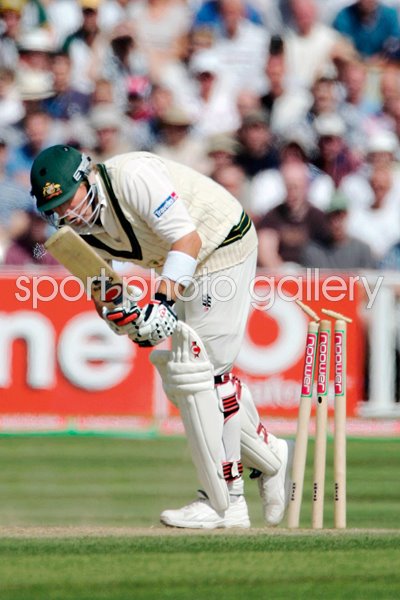 Shane Warne steps onto his stumps