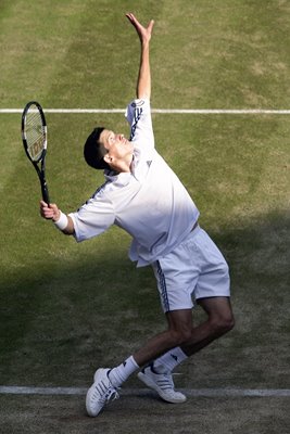 Tim Henman serves