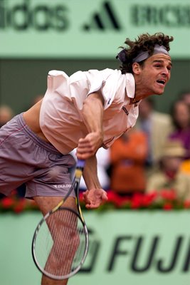 Gustavo Kuerten of Brazil serves 