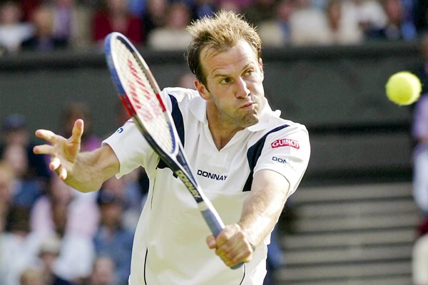 Greg Rusedski plays a backhand