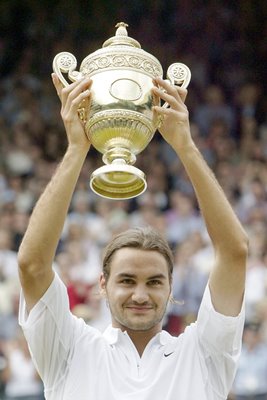 Roger Federer of Switzerland holds the trophy aloft after his victory over Mark Philippoussis of Australia in the mens singles final