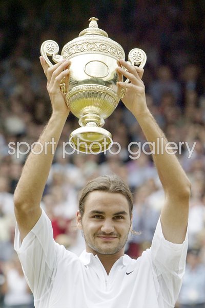 Roger Federer of Switzerland holds the trophy aloft after his victory over Mark Philippoussis of Australia in the mens singles final