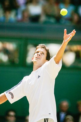 Tim Henman serves