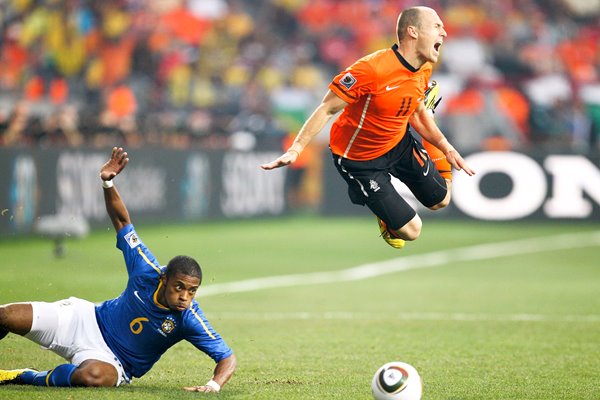 Arjen Robben dives over the Brazilian tackle