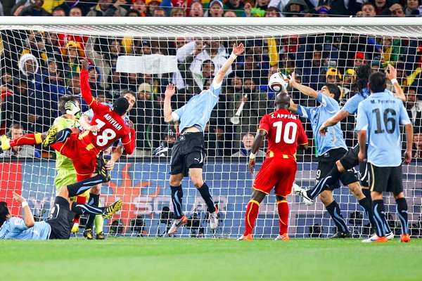 Luis Suarez of Uruguay handles the ball v Ghana