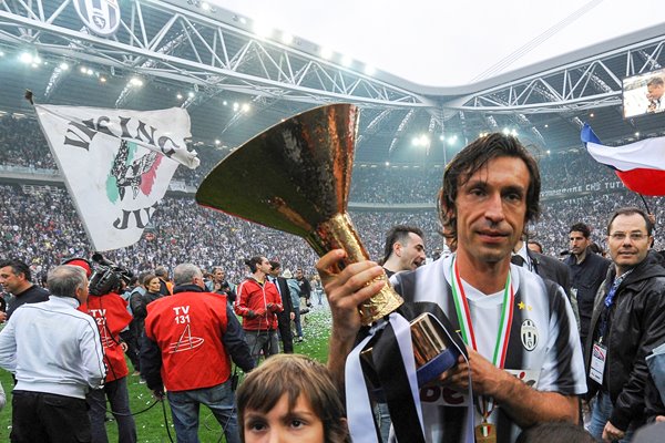 Andrea Pirlo celebrates with the Serie A trophy