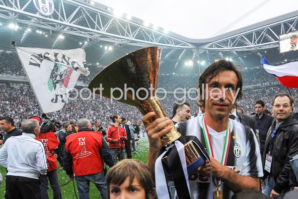 Andrea Pirlo celebrates with the Serie A trophy