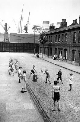 Children play street cricket London 1938