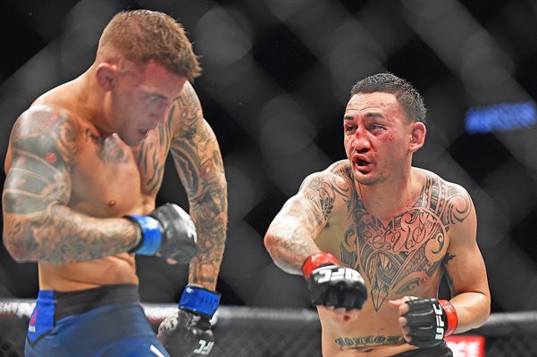 Max Holloway punches Dustin Poirier UFC 236 Atlanta 2019