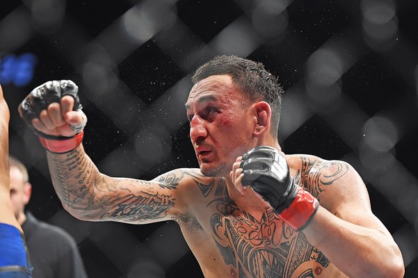 Max Holloway punches Dustin Poirier UFC 236 Atlanta 2019