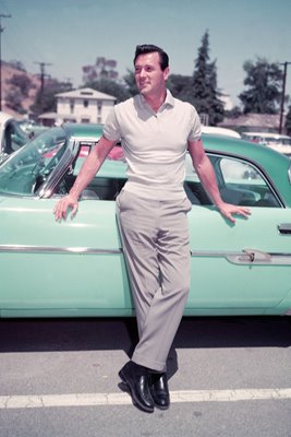 Rock Hudson leaning on car 1955