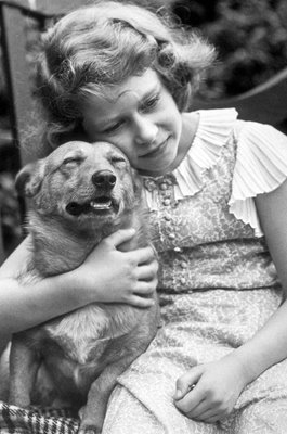 Princess Elizabeth hugging a corgi dog 1936