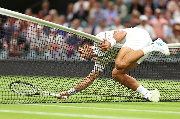 Novak Djokovic Serbia falls over the net v Hubert Hurkacz Wimbledon 2023