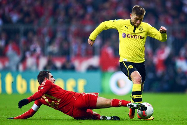 Philipp Lahm of Bayern challenges Jakub Blaszczykowski of Borussia
