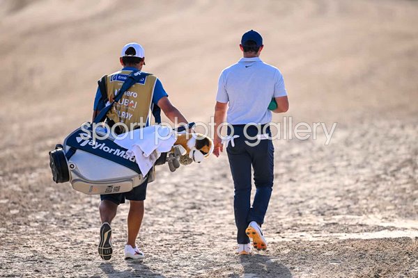 Rory McIlroy & caddie Harry Diamond walk towards Dubai Desert Classic win 2024