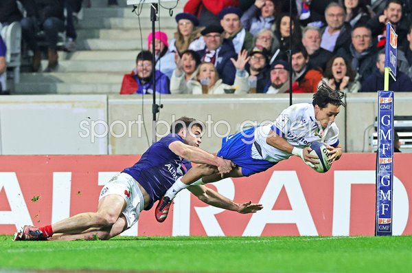 Ange Capuozzo Italy tackled by Damian Penaud as he scores v France Six Nations 2024