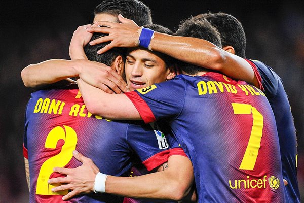 Alexis Sanchez of FC Barcelona embraced by his team-mates