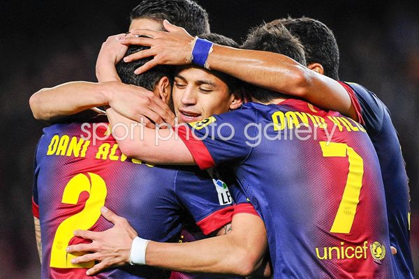 Alexis Sanchez of FC Barcelona embraced by his team-mates