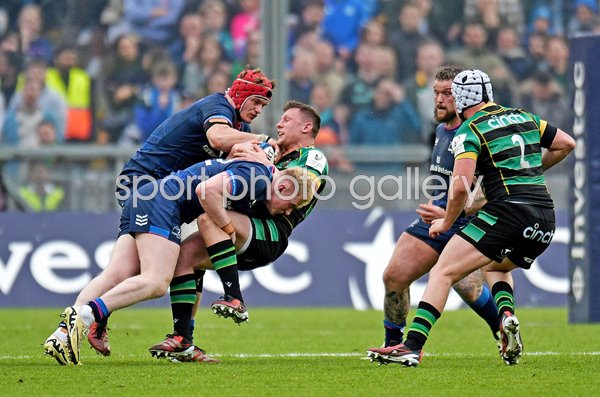 Fraser Dingwall Northampton tackled by Jamie Osborne & Josh van der Flier Leinster Champions Cup 2024