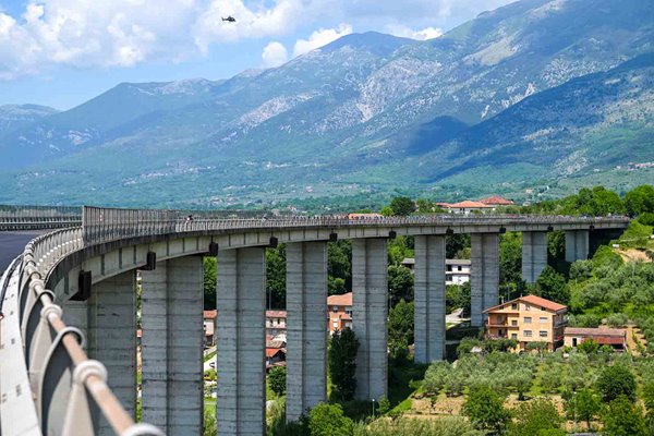 Peloton crosses bridge Avezzano to Naples Stage 9 Giro d'Italia 2024 