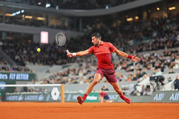 Novak Djokovic Serbia sliding backhand v Lorenzo Musetti French Open Paris 2024