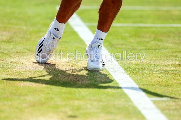 General view player serving feet behind baseline Grass Court 2024