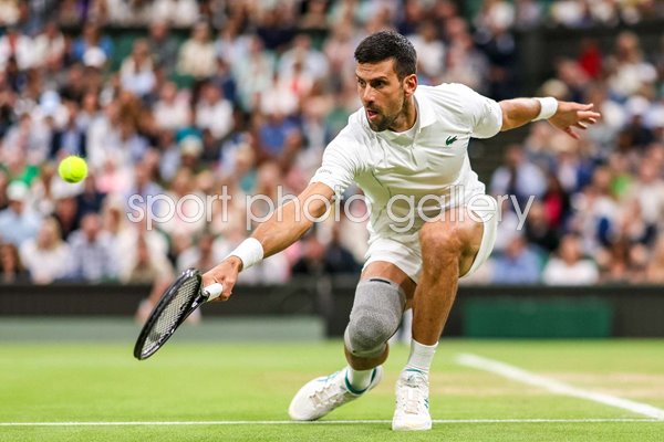 Novak Djokovic Serbia low backhand v Holger Rune Denmark Wimbledon 2024