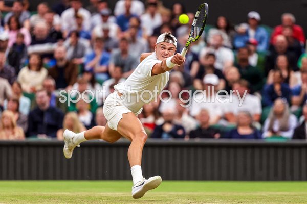 Holger Rune Denmark stretch backhand v Novak Djokovic Wimbledon 2024