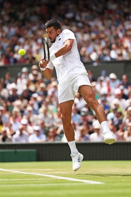Novak Djokovic Serbia plays a backhand v Alex De Minaur Wimbledon 2025