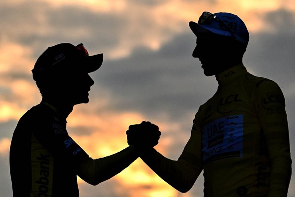 Silhouet of Jonas Vingegaard and Tadej Pogacar congratulate each other at podium during the 112th Tour de France 2025, Stage 21