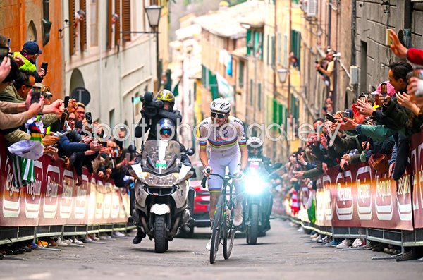 Tadej Pogacar smiles climbing iconic Via Santa Caterina Strade Bianche 2026