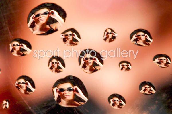 Portrait of a swimmer through water drops