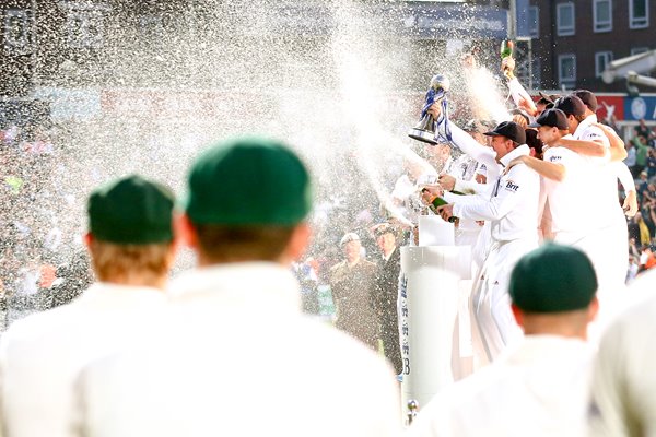 Australian players look on as England lift the urn Ashes 2013