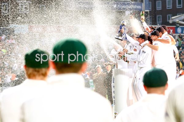 Australian players look on as England lift the urn Ashes 2013