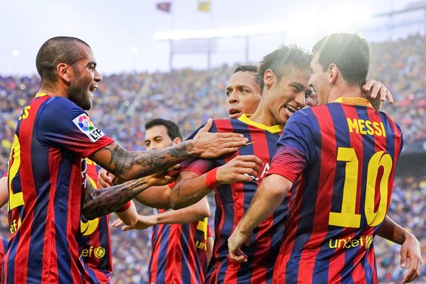 Neymar celebrates with Lionel Messi and team mates