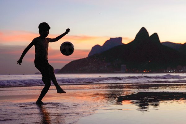 Juggling a football on Ipanema Beach
