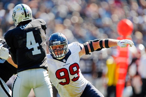  Derek Carr Oakland takes hit  J.J. Watt Houston