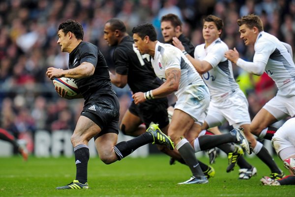 Dan Carter of New Zealand makes a break v England