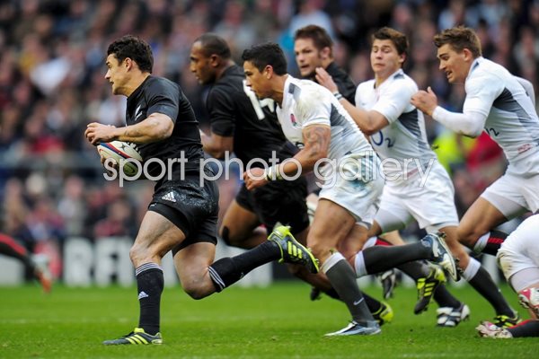 Dan Carter of New Zealand makes a break v England